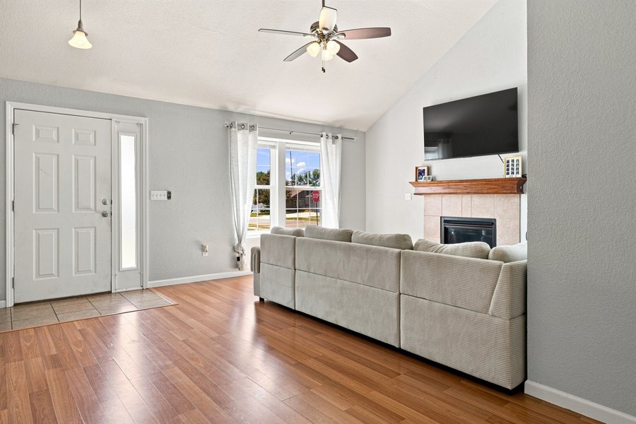 Living room with vaulted ceiling and front windows